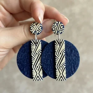Paire de boucles d'oreilles bleues et beiges avec verso latte tenue en main